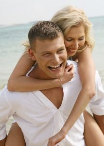 Happy young couple having fun on the beach