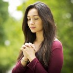 Woman praying outdoors