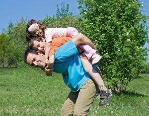 Happy family playing outdoors