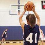 Female High School Basketball Player Shooting Basket