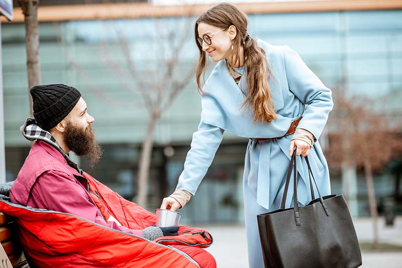 woman giving money for a homeless beggar 2023 11 27 05 22 39 utc