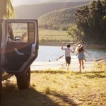 family reaching destination by lake after road trip