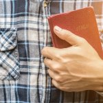a man reading the holy bible.