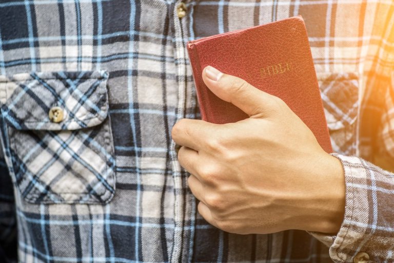 a man reading the holy bible.