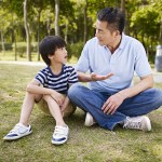 asian father and son having a conversation